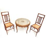 A pair of Edwardian mahogany and inlaid cane seated bedroom chairs and a circular occasional table