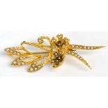 A 9ct yellow gold seed pearl and garnet set stylised floral brooch, length 4.5cm, approx 5.7g.