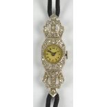 An early 20th century platinum and diamond manual wind lady's cocktail wristwatch,