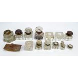 A group of various glass inkwells including a pair with gilt tooled leather tops and spring loaded