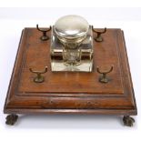 A 19th century oak ink stand with brass fitments and ball and claw feet, 19 x 19cm,