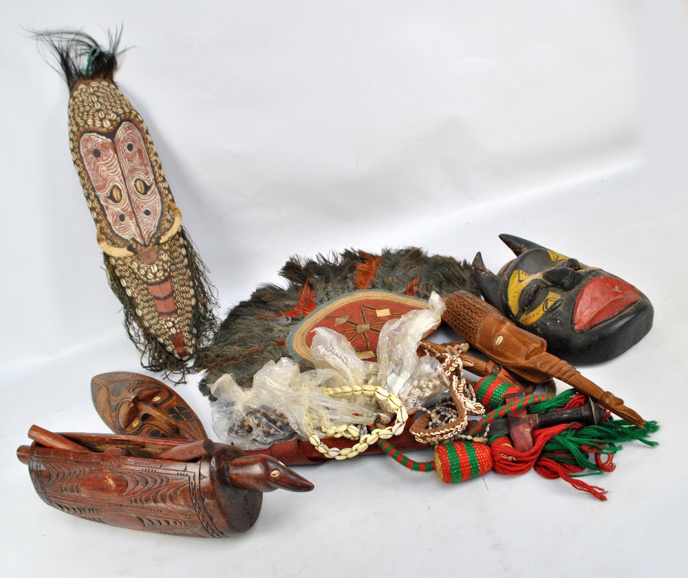 A group of ethnic items to include Papua New Guinea mask inset with shells, further masks,