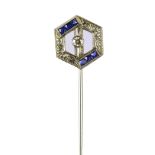 An 18ct white gold Art Deco stick pin of open hexagonal form centred with a round cut diamond,