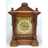 WINTERHALDER & HOFMEIER; an oak cased mantel clock with carved foliate decoration,