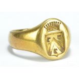 A yellow metal signet ring with coat of arms seal to oval platform, unmarked, size N1/2, approx 12.