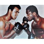 A photograph of Muhammad Ali and Joe Fraser squaring off, signed by both boxers,