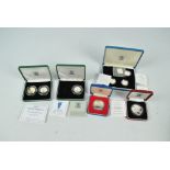 A collection of boxed silver proof coins comprising a 1977 Silver Jubilee crown,