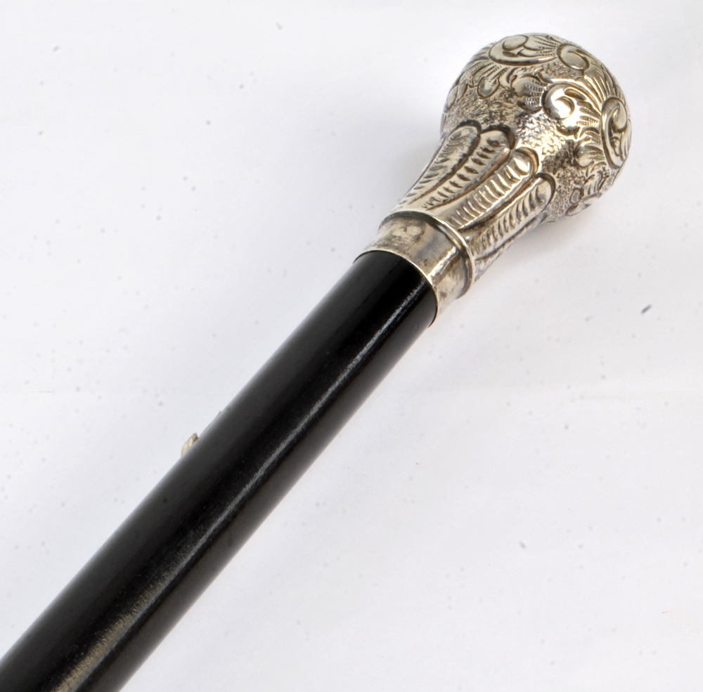 A white metal topped ebonised walking cane, length 96cm.