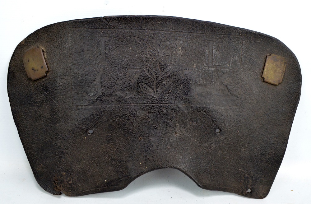 An unusual 18th century leather section of saddle embossed with a flower and inscribed 'IL, 1776',