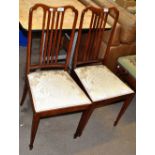 A pair of Edwardian inlaid bedroom chairs.