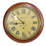 A circa 1900 mahogany and stained beech circular wall clock with painted dial set with Roman