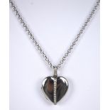 An 18ct white gold heart shaped locket pendant with band of eleven melee diamonds to the front and