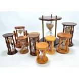 A collection of treen egg timers of varied size and form, the tallest 28.5cm, over forty in total.