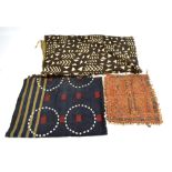 An African tribal wall hanging set with four rows of five circular medallions arranged with shells