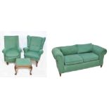 A matched four piece green upholstered lounge suit comprising settee, two chairs and a stool.