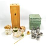 A boxed travelling sake set with two bottles and five cups and a further boxed travelling set (2).