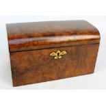 A Victorian figured walnut tea caddy with domed lid enclosing twin sectioned interior with lids,