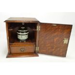 An oak smoker's cabinet with internal ceramic lidded jar and single shelf, 26.5 x 23cm.