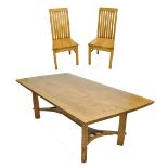 An Arts and Crafts style contemporary oak dining table of rectangular form with slightly rounded