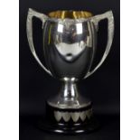 A large silver plated twin handled trophy cup with Celtic decoration,