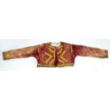 A velvet embroidered short jacket with gold thread detail and traces of original deep burgundy