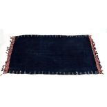 A south Tunisian hand dyed blue ground shawl with embroidered detail to the shoulder,