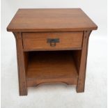 An Arts and Crafts style oak side table with single drawer above shelf, width 57cm, height 60cm.