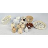 A small collection of 19th century stoneware pie funnels and a group of small jelly moulds,