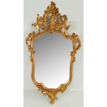 An 18th century Continental giltwood rococo mirror, total approx 100cm x 55cm.