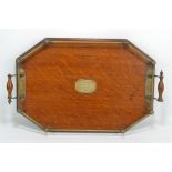 An Edwardian oak and silver plated twin handled tea tray of shaped rectangular form inscribed to a