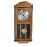 An oak cased wall clock, the silvered circular dial set with Arabic numerals, dial diameter 18cm,