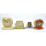 Three Art Deco style variously coloured onyx timepieces and a chrome example (4).