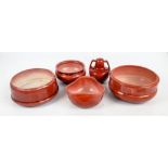 BRETBY; a group of five red glazed items comprising two large shallow bowls, a trefoil shaped bowl,