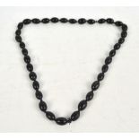 An oval horn bead necklace, individually knotted, the larger beads approx 2.5 x 1.