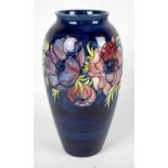 MOORCROFT; a large 'Anemone' pattern tubeline decorated ovoid vase on dark blue ground,