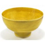 LUCIE RIE (1902-1995); a porcelain footed bowl covered in mustard yellow glaze, impressed LR mark,