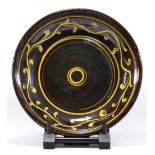 CLIVE BOWEN (born 1943); a large slipware dish, trailed yellow decoration on dark treacle ground,