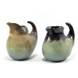 ABDO NAGI (1941-2001); a near pair of 'slipper' jugs made of T-material,