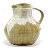 WILLIAM MARSHALL (1923-2007); a squat stoneware jug covered in green ash glaze with Chun pours,