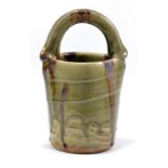 TAKESHI YASUDA (born 1943); a stoneware basket, green ash glaze with iron pours,