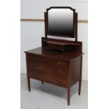 An Edwardian mirror-back dressing table with lower shelf and small drawer above three long drawers