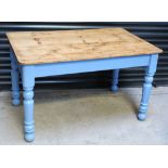 An Edwardian pine-topped kitchen table on blue-painted baluster supports, 76 x 122cm.