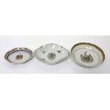 Three 18th century armorial bowls; an oval monochrome and gilt-heightened dish,