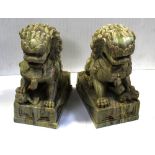 A pair of 20th century onyx dogs of Fo on florally decorated plinth base, height 23cm (2).