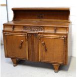 An oak sideboard with carved detail, three drawers above twin cupboard doors, 91.5 x 132cm.