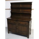 An Ercol 'Old Colonial' style dresser with two plate racks above two frieze drawers,