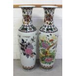 A large pair of contemporary Oriental baluster vases decorated with peonies, flora, figures,