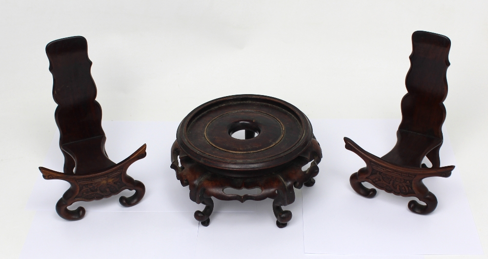 A Chinese hardwood stand and a pair of plate stands (3).