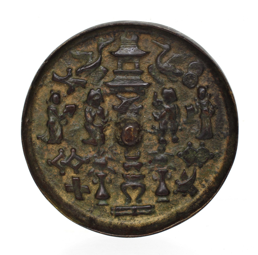 An Oriental round bronze plaque with figural decoration, diameter 10.5cm.