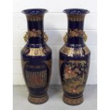 A pair of Oriental cobalt blue ground baluster vases with bird and flora decoration,